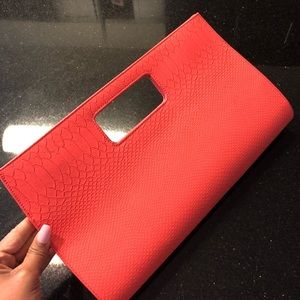 Oversized peach clutch with faux snakeskin detail